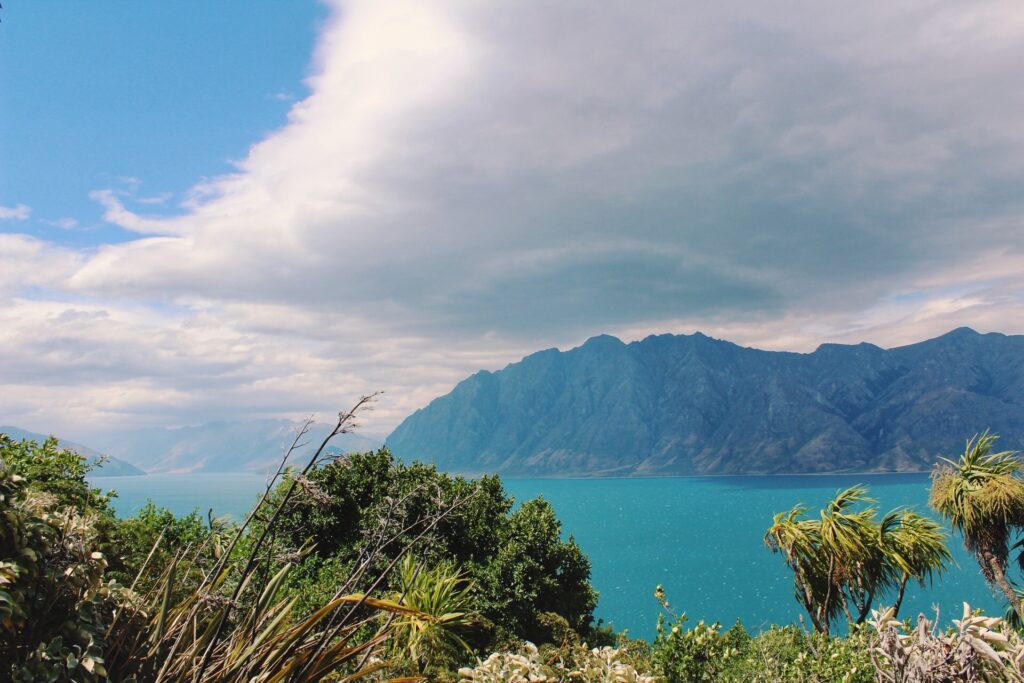 view near wanaka, new zealand. bright blue lake with mountains