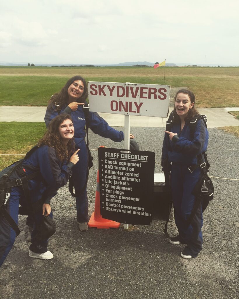 melody an friends at skydive taupo new zealand. standing infront of skydivers only sign