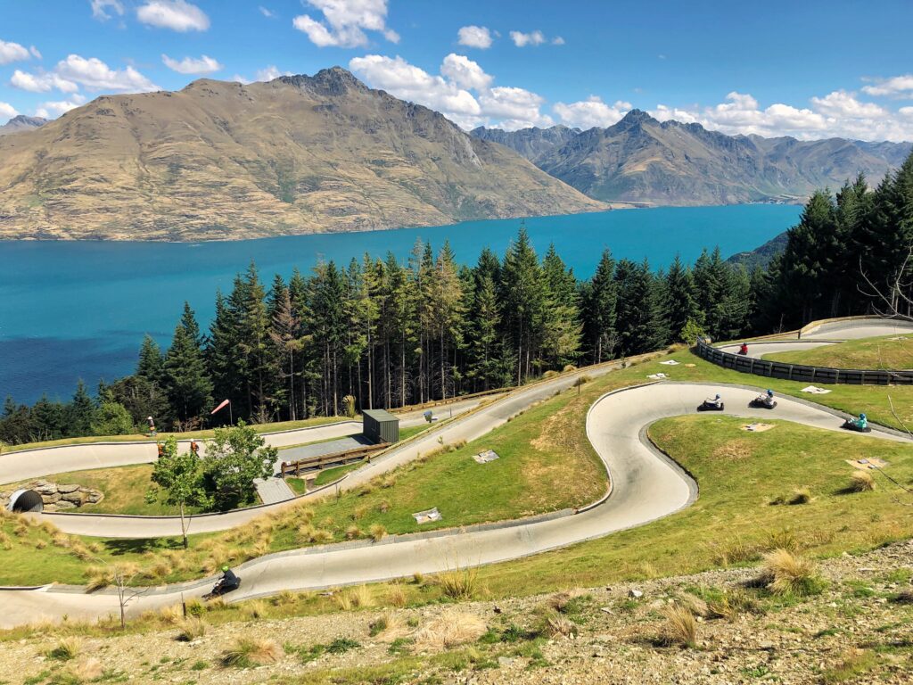 luge in queenstown, new zealand. lake and mountains in background