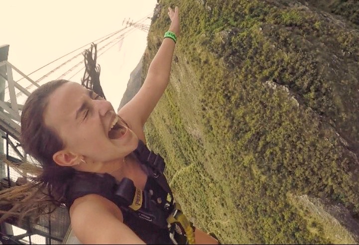 selfie of melody mid-jump on bungy jump in queenstown, new zealand