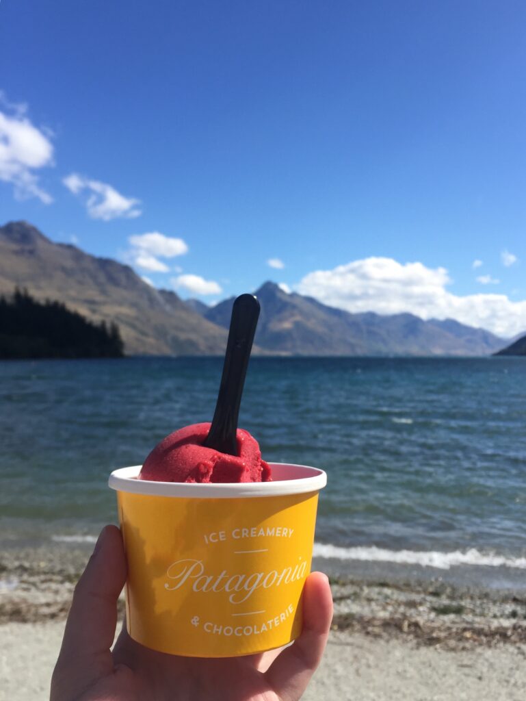 ice cream in front of lake with mountains in background, queenstown