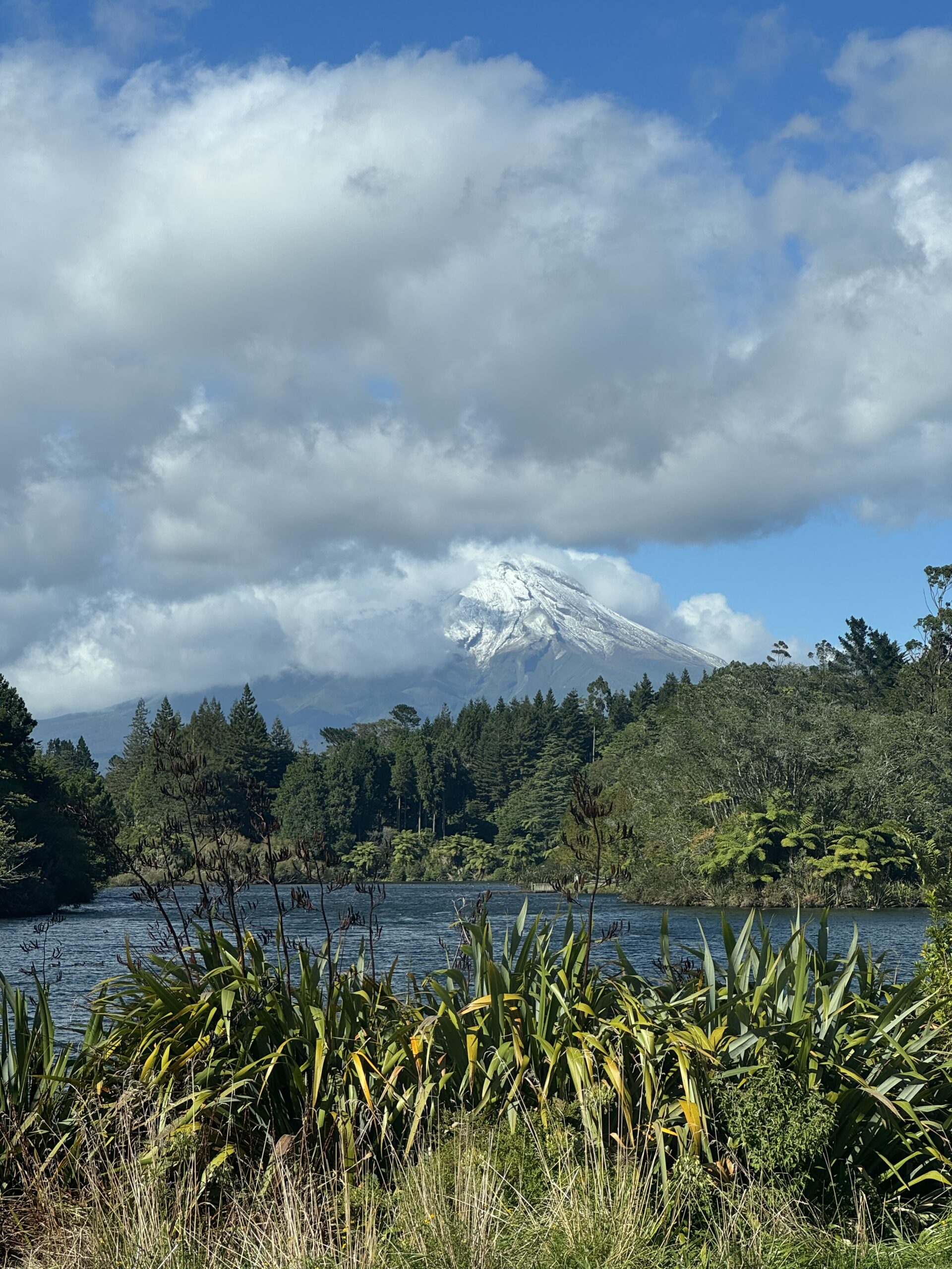 lake in foreground and mount taranaki in background, new zealand