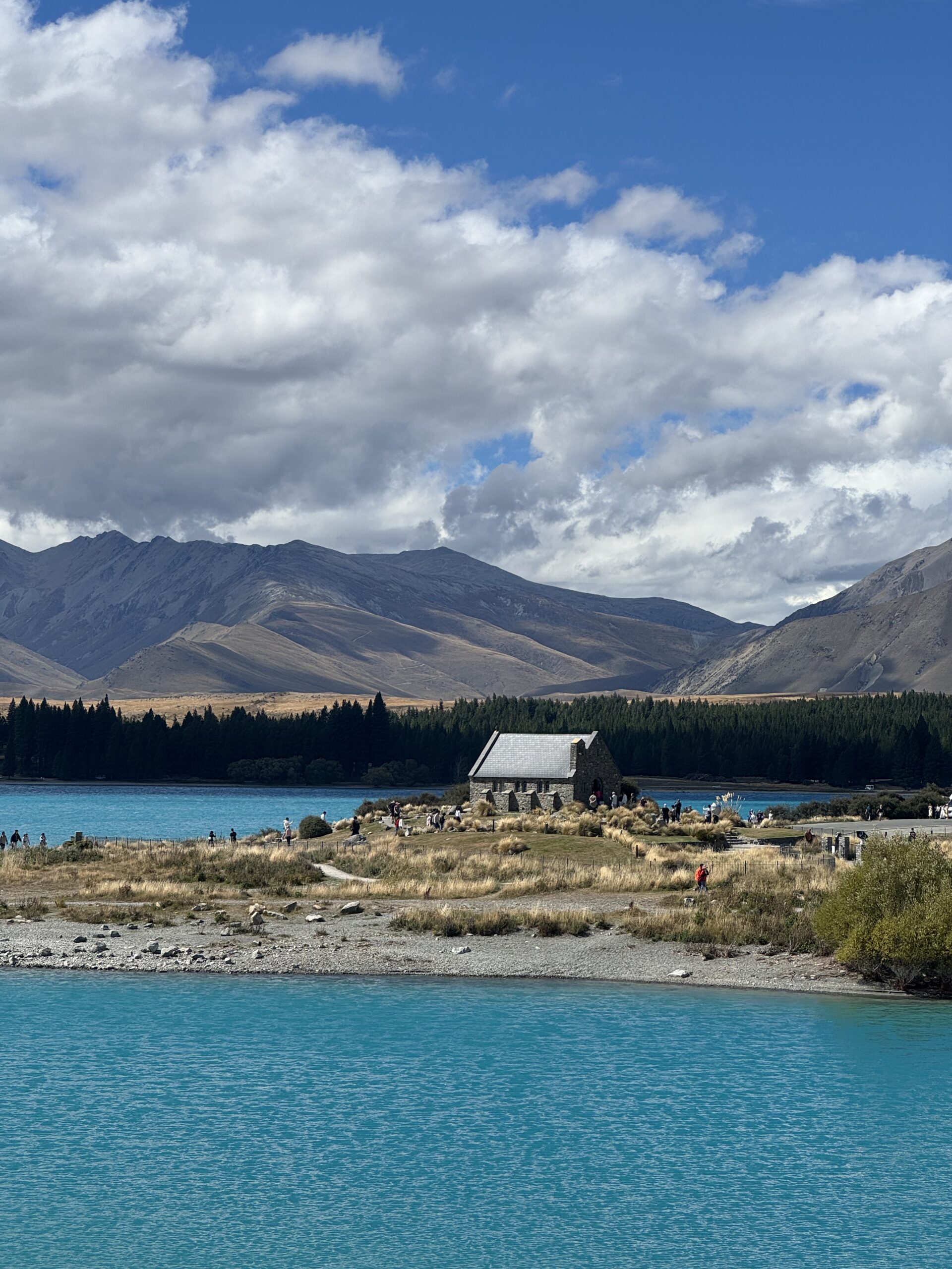 zoomed out photo of church of good hope, lake tekapo, new zealand.
