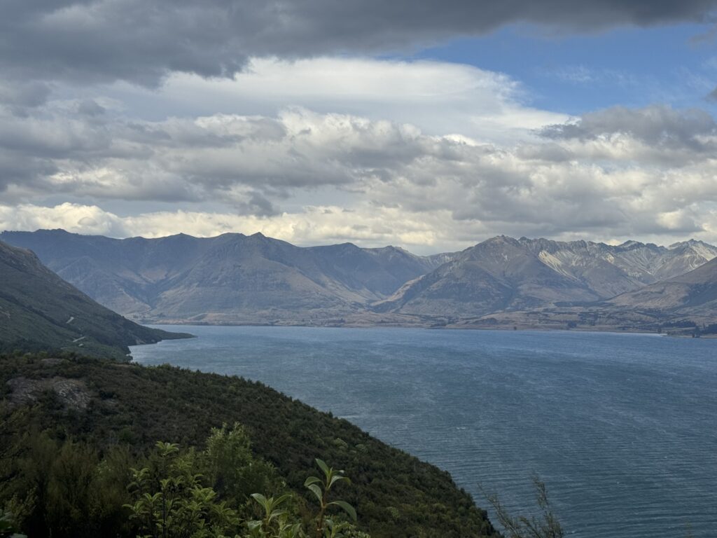 view of lake and mountains on road to glenorchy, new zealand