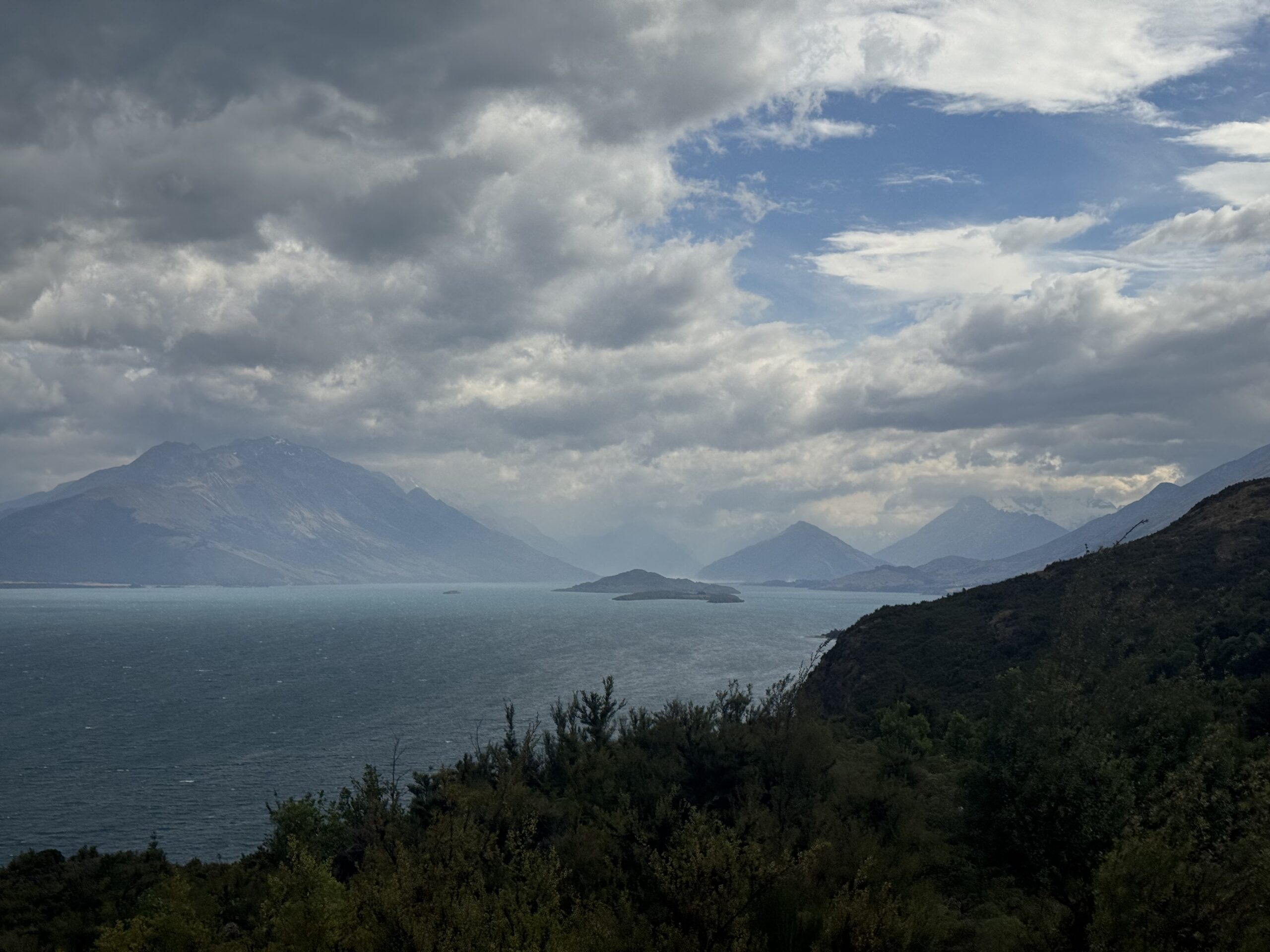view of lake and mountains on road to glenorchy, new zealand