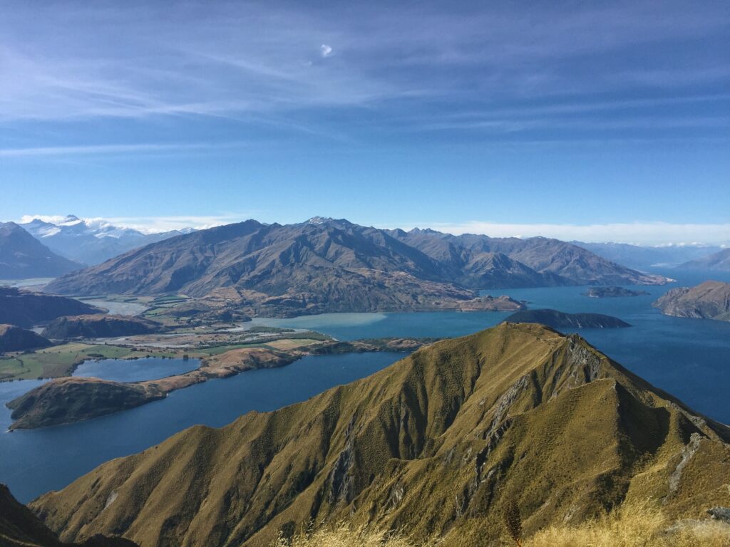 view from roys peak, wanaka, new zealand. surrounded by lake and mountains