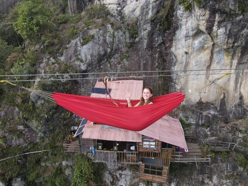 melody on a hammock dangling in the air infront of la casa in el aire, colombia